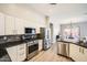 Bright, efficient kitchen featuring stainless appliances, white cabinets, and open layout to dining at 3904 E Carter Dr, Phoenix, AZ 85042