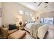 Inviting main bedroom with a cozy sitting area, neutral tones, and modern fixtures at 3904 E Carter Dr, Phoenix, AZ 85042