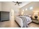 Bright main bedroom features a ceiling fan, tile floors, and clerestory windows above the bed at 3904 E Carter Dr, Phoenix, AZ 85042