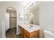 Bathroom featuring a vanity with storage and a walk in closet, providing plenty of convenience and style at 40144 N Lerwick Dr, San Tan Valley, AZ 85140