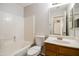 Bright bathroom featuring a shower-tub combo with white tile surround and wood vanity at 40144 N Lerwick Dr, San Tan Valley, AZ 85140