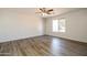 Bright bedroom with a modern ceiling fan and light hardwood floors, offering a clean and inviting space at 40144 N Lerwick Dr, San Tan Valley, AZ 85140