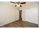 Cozy bedroom with a ceiling fan and hardwood floors, providing a comfortable and stylish living space at 40144 N Lerwick Dr, San Tan Valley, AZ 85140