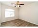 Well-lit bedroom with a large window and modern wood-look flooring at 40144 N Lerwick Dr, San Tan Valley, AZ 85140