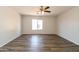 Spacious bedroom with neutral walls, ceiling fan, and new modern flooring at 40144 N Lerwick Dr, San Tan Valley, AZ 85140