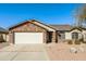 Charming single-story home featuring a brick facade and two-car garage, complemented by a well-maintained landscape at 40144 N Lerwick Dr, San Tan Valley, AZ 85140