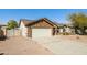 Charming brick home featuring a two-car garage and desert landscaping at 40144 N Lerwick Dr, San Tan Valley, AZ 85140