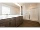 Bathroom with double sink vanity, wood tile floors, and glass shower at 40250 N Alegre Dr, San Tan Valley, AZ 85140