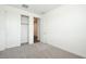 Neutral bedroom features open closet, carpeting, and doorway at 40250 N Alegre Dr, San Tan Valley, AZ 85140