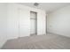 Bright carpeted bedroom featuring open closet and white walls at 40250 N Alegre Dr, San Tan Valley, AZ 85140