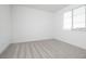Well-lit bedroom features neutral carpet and a bright window at 40250 N Alegre Dr, San Tan Valley, AZ 85140