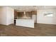 Bright kitchen with white quartz island, tile backsplash, wooden cabinets, stainless hood and appliances at 40250 N Alegre Dr, San Tan Valley, AZ 85140