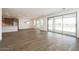 Spacious open-concept living room and kitchen with wood-look tile floors, recessed lighting, and sliding glass doors at 40250 N Alegre Dr, San Tan Valley, AZ 85140