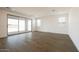 Spacious living room with wood tile flooring and sliding glass doors for natural light at 40250 N Alegre Dr, San Tan Valley, AZ 85140