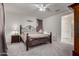 Cozy bedroom featuring carpet, ceiling fan, and an ornate wrought iron bed frame at 4116 E Roy Rogers Rd, Cave Creek, AZ 85331