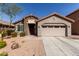 Charming single-story home featuring a stone facade, well-maintained landscaping, and a two car garage at 4116 E Roy Rogers Rd, Cave Creek, AZ 85331