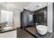 Contemporary bathroom featuring a soaking tub, sleek glass shower, and double sink vanity with black marble countertop at 4422 N 75Th St # 8005, Scottsdale, AZ 85251