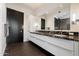 Modern bathroom featuring a double sink vanity with black marble countertop and ample cabinet space at 4422 N 75Th St # 8005, Scottsdale, AZ 85251