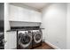 Practical laundry room equipped with modern, front-loading washer and dryer and ample storage space at 4422 N 75Th St # 8005, Scottsdale, AZ 85251