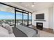 Main bedroom with a fireplace, ceiling fan and expansive views at 4422 N 75Th St # 8005, Scottsdale, AZ 85251