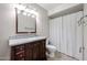 Bathroom showcasing a wood vanity with granite countertop and a shower with a white curtain at 4523 W Bluefield Ave, Glendale, AZ 85308