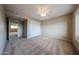 Neutral bedroom featuring neutral walls, carpet, ceiling fan, and a closet with sliding doors at 4523 W Bluefield Ave, Glendale, AZ 85308