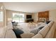 Spacious living room featuring a large sectional couch, brick fireplace, and sliding glass doors at 4523 W Bluefield Ave, Glendale, AZ 85308