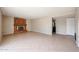 Open living area with tile flooring, brick fireplace, and hallway to bedrooms at 4523 W Bluefield Ave, Glendale, AZ 85308