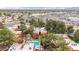 Aerial view of the community, showcasing proximity to shopping centers, roads, mature trees, and pool at 4704 E Paradise Village Pkwy # 213, Phoenix, AZ 85032