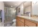 Bathroom featuring a granite countertop vanity and walk-in shower with glass door at 4704 E Paradise Village Pkwy # 213, Phoenix, AZ 85032