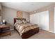 Bedroom featuring a queen bed with a decorative headboard and a walk-in closet at 4704 E Paradise Village Pkwy # 213, Phoenix, AZ 85032