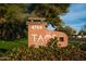 A welcoming community sign for The Taos Condominiums, surrounded by lush greenery, sets a friendly tone at 4704 E Paradise Village Pkwy # 213, Phoenix, AZ 85032