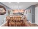 Open dining room area featuring hardwood floors and decorative wall art with kitchen in the background at 4704 E Paradise Village Pkwy # 213, Phoenix, AZ 85032