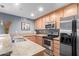 A kitchen features granite countertops, stainless steel appliances, and hardwood cabinets at 4704 E Paradise Village Pkwy # 213, Phoenix, AZ 85032