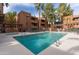 Community pool with lounge chairs and a view of the surrounding buildings at 4704 E Paradise Village Pkwy # 213, Phoenix, AZ 85032