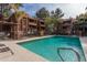 Community pool surrounded by lounge chairs and fence at 4704 E Paradise Village Pkwy # 213, Phoenix, AZ 85032