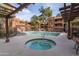 Community pool with jacuzzi surrounded by lounge chairs and view of the community at 4704 E Paradise Village Pkwy # 213, Phoenix, AZ 85032