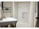 Bright bathroom with glass shelving, black and white subway tile and stylish decor at 5101 N Casa Blanca Dr # 217, Paradise Valley, AZ 85253