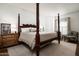 Spacious bedroom featuring a decorative dark wood four poster bed and stylish furnishings at 5101 N Casa Blanca Dr # 217, Paradise Valley, AZ 85253