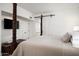 Bedroom featuring a decorative dark wood four poster bed and a barn-style sliding door at 5101 N Casa Blanca Dr # 217, Paradise Valley, AZ 85253