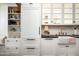 Kitchen featuring white cabinets, black countertops, stainless hardware and a farmhouse style sink at 5101 N Casa Blanca Dr # 217, Paradise Valley, AZ 85253