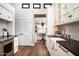 Well-lit white kitchen with stainless steel appliances, farmhouse sink and plenty of cabinet space at 5101 N Casa Blanca Dr # 217, Paradise Valley, AZ 85253