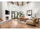 Bright living room featuring a fireplace, wood flooring, exposed beams, and access to the backyard at 5101 N Casa Blanca Dr # 217, Paradise Valley, AZ 85253