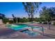 Sparkling community pool and hot tub surrounded by lush landscaping and lounge seating at 5101 N Casa Blanca Dr # 217, Paradise Valley, AZ 85253