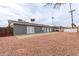 Large, fenced backyard features a gravel area and covered patio at 5208 W Earll Dr, Phoenix, AZ 85031