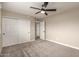 Bedroom with neutral tones featuring a ceiling fan and a closet at 5208 W Earll Dr, Phoenix, AZ 85031