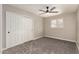 Bedroom featuring a ceiling fan, a closet, and brick accent wall at 5208 W Earll Dr, Phoenix, AZ 85031