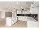 Clean kitchen offers a quartz counter breakfast bar, and white cabinetry at 5208 W Earll Dr, Phoenix, AZ 85031