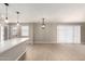 Bright eat-in kitchen with quartz counters, modern pendant lights, and light wood floors at 5208 W Earll Dr, Phoenix, AZ 85031