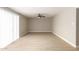 Neutral living room featuring a ceiling fan, light wood flooring, and a sliding glass door at 5208 W Earll Dr, Phoenix, AZ 85031